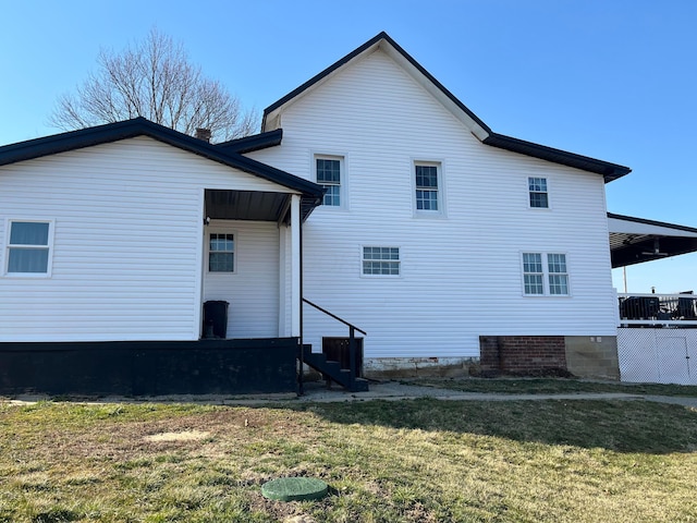 rear view of house with a yard