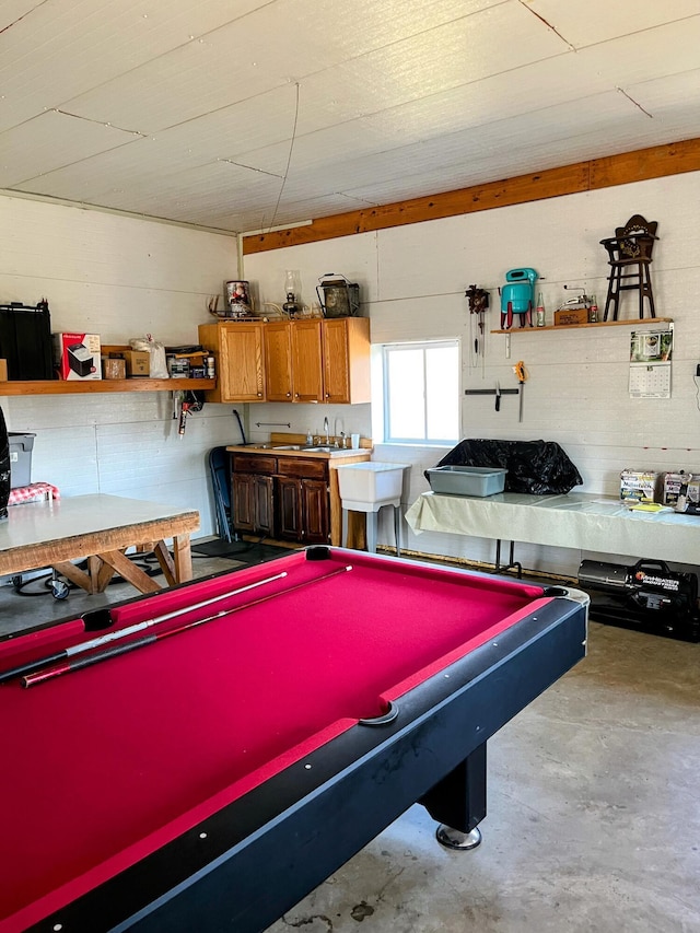 rec room with a sink and concrete floors