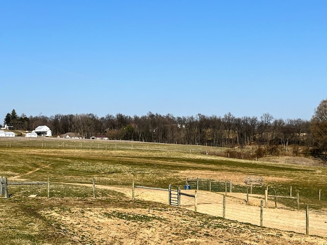 view of yard featuring a rural view and fence