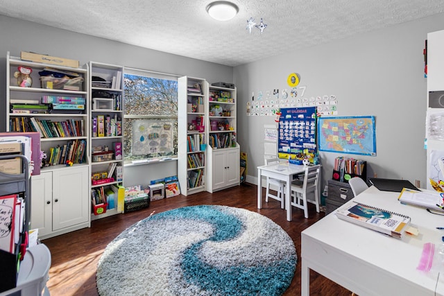 interior space with a textured ceiling and wood finished floors