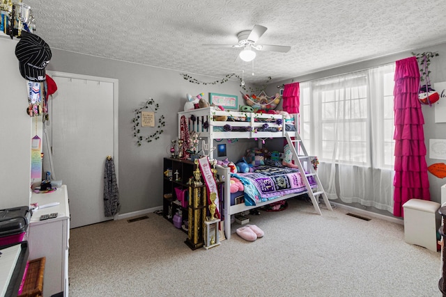 bedroom with visible vents, a textured ceiling, carpet, and ceiling fan