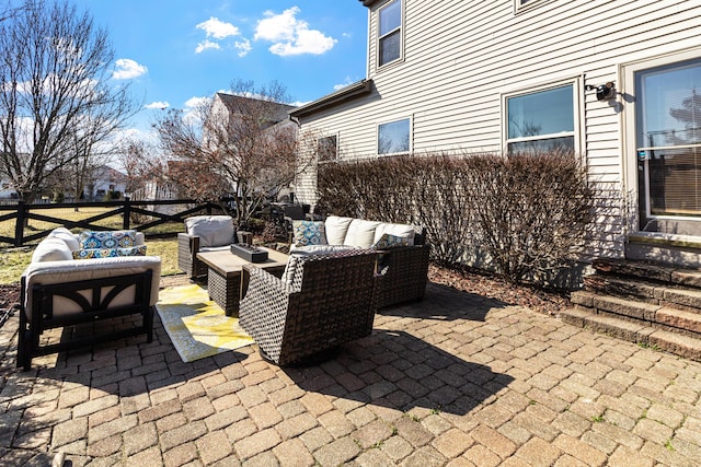 view of patio featuring entry steps, outdoor lounge area, and fence