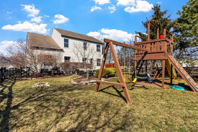 view of playground with a yard and fence