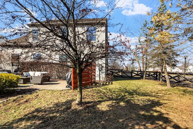 view of yard featuring an outdoor living space, a patio, and fence