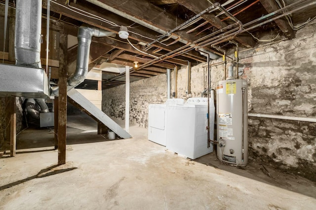 unfinished below grade area featuring separate washer and dryer and water heater