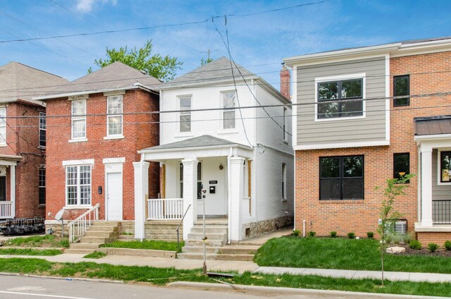 550 W Town St, Columbus, OH 43215 - view of front of property featuring brick siding and a porch