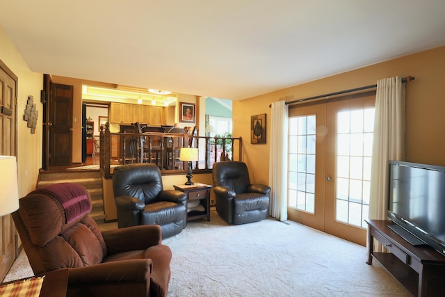 carpeted living room featuring plenty of natural light and french doors