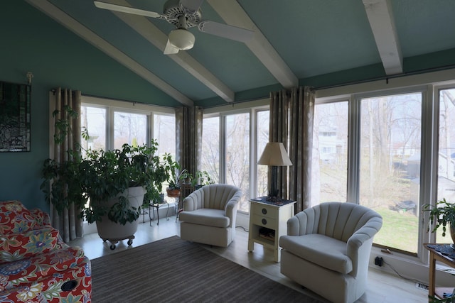 sunroom featuring lofted ceiling with beams, plenty of natural light, and ceiling fan