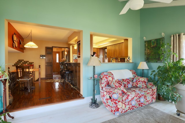 living area featuring wood finished floors and a ceiling fan