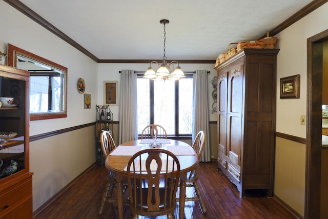 dining space with an inviting chandelier, dark wood-style flooring, and ornamental molding