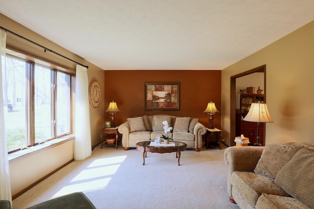 carpeted living area featuring baseboards