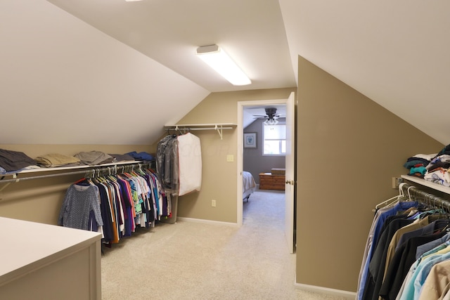 spacious closet with light carpet and lofted ceiling