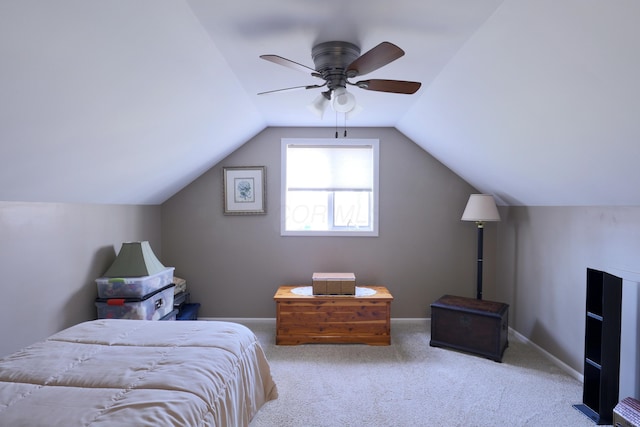 carpeted bedroom with lofted ceiling, a ceiling fan, and baseboards