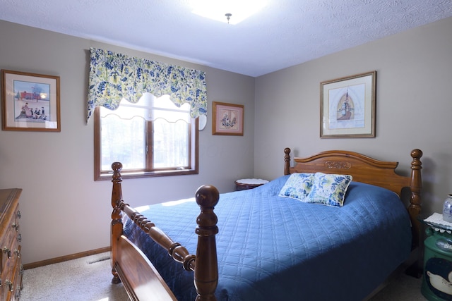 bedroom with visible vents, baseboards, carpet, and a textured ceiling