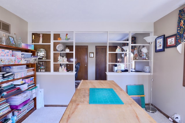 carpeted home office featuring visible vents and baseboards