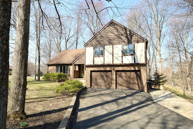 view of front of property featuring brick siding, driveway, and stucco siding