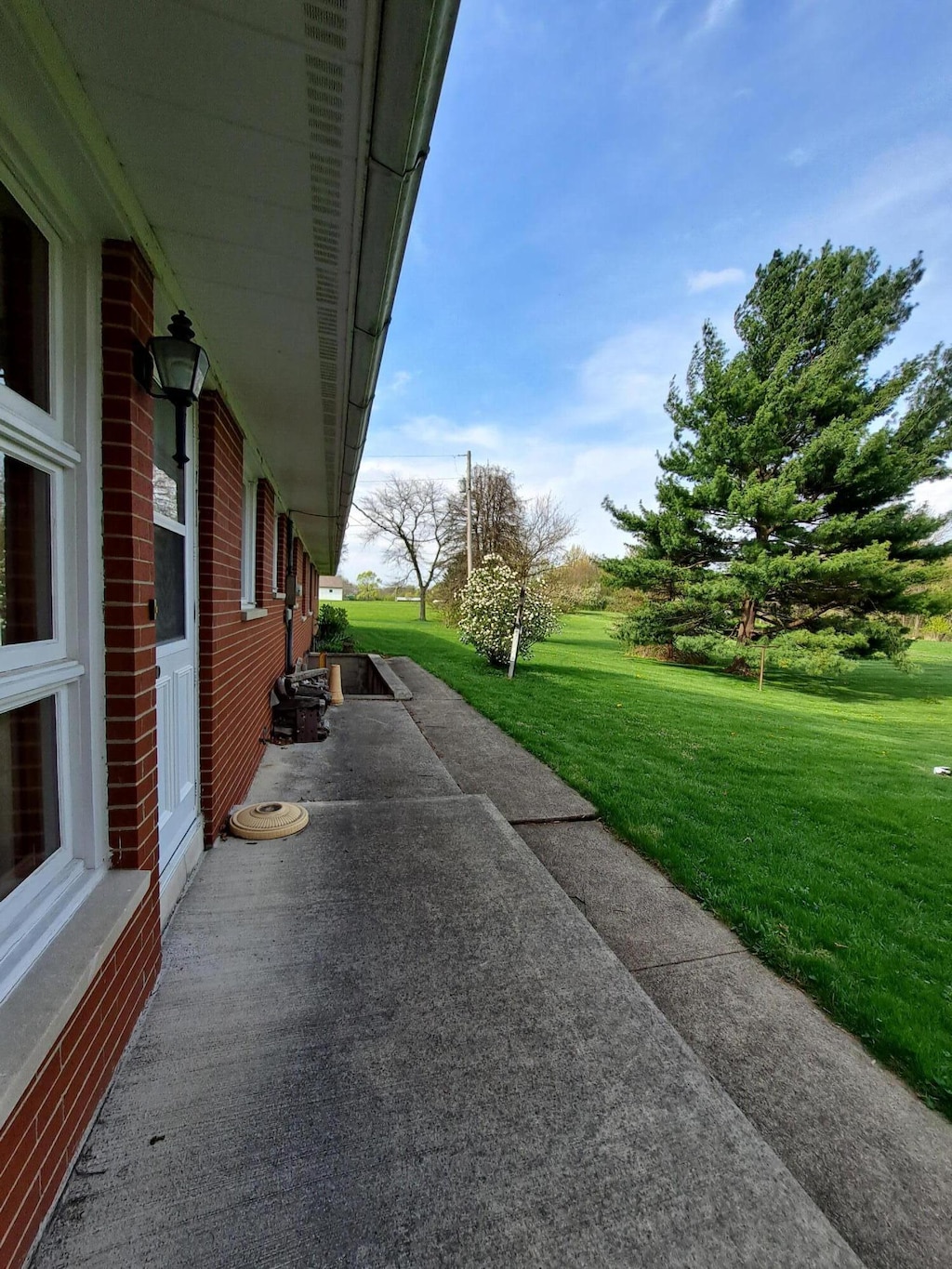 view of side of home with a yard