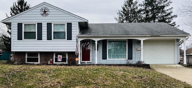 split level home featuring driveway, a front lawn, a garage, and roof with shingles