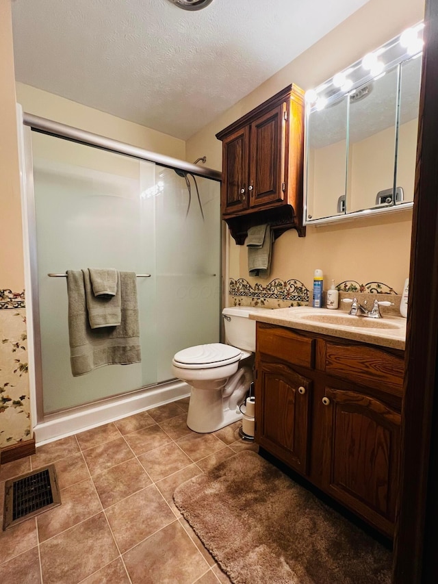 bathroom featuring vanity, visible vents, a stall shower, a textured ceiling, and toilet