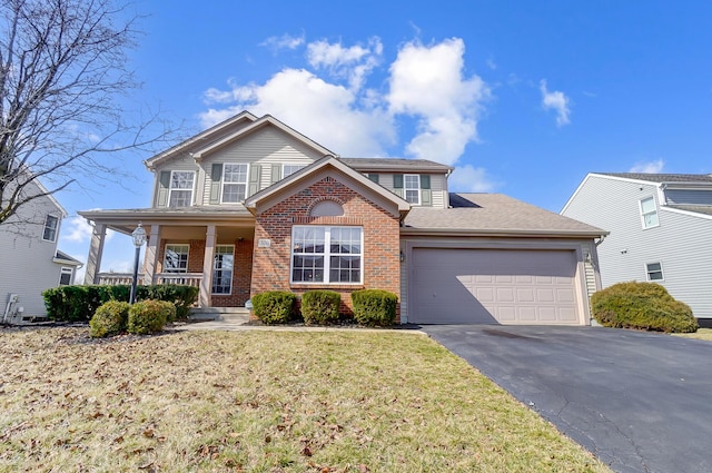 view of front of house featuring an attached garage, covered porch, a front lawn, aphalt driveway, and brick siding