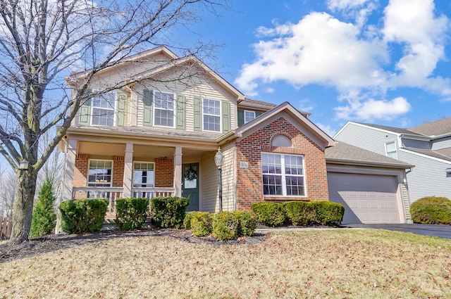 view of front of home featuring a garage, covered porch, brick siding, and driveway