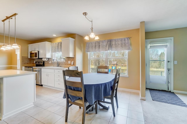 dining space featuring light tile patterned floors and baseboards