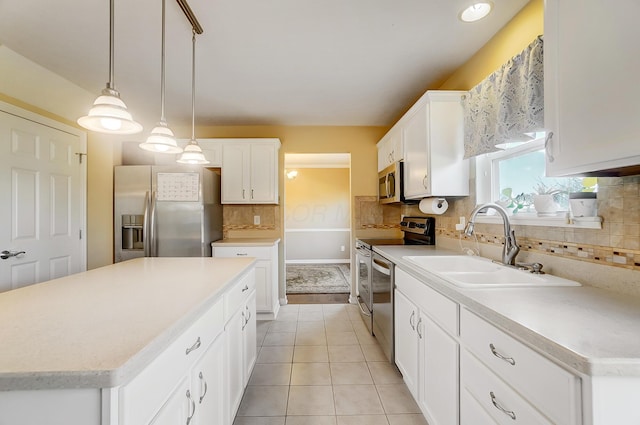 kitchen with white cabinetry, light tile patterned floors, appliances with stainless steel finishes, and a sink