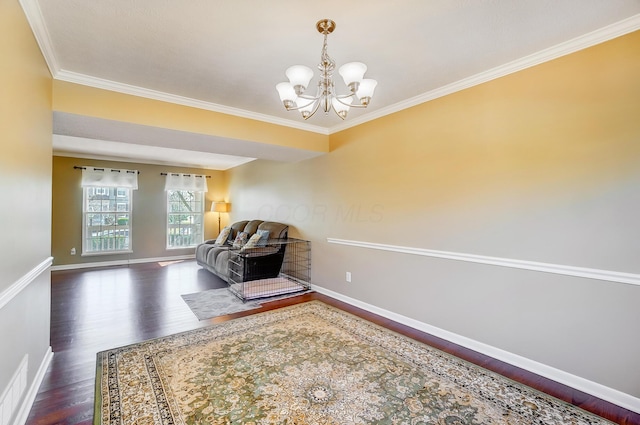 living area with crown molding, baseboards, dark wood-type flooring, and an inviting chandelier