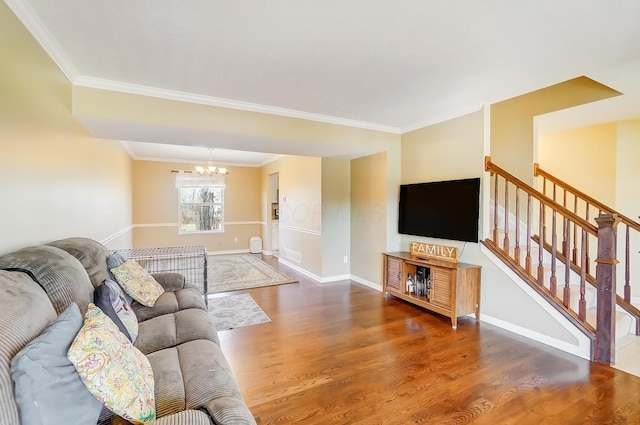 living room with visible vents, ornamental molding, wood finished floors, an inviting chandelier, and baseboards