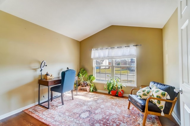 home office featuring baseboards, wood finished floors, and vaulted ceiling