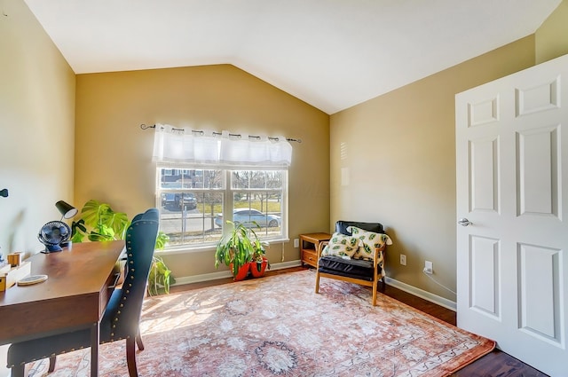 office area with lofted ceiling, wood finished floors, and baseboards