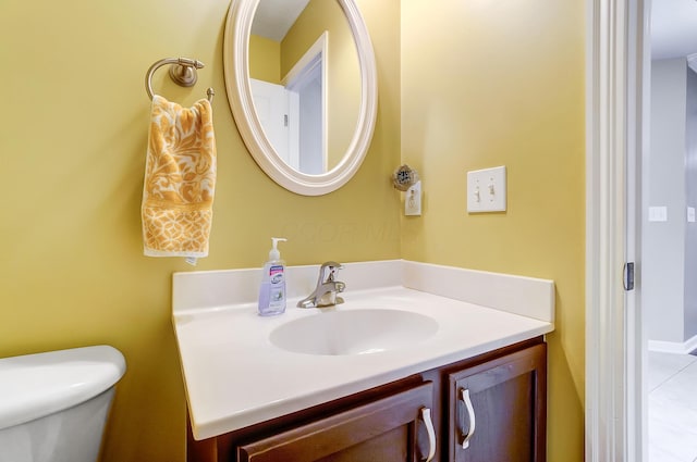 bathroom featuring vanity and toilet