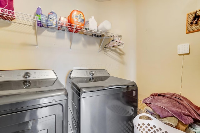 laundry room with laundry area and washing machine and clothes dryer