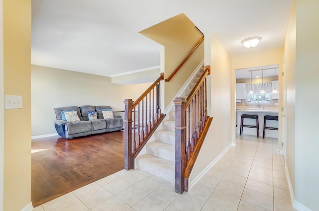 stairs with tile patterned floors and baseboards