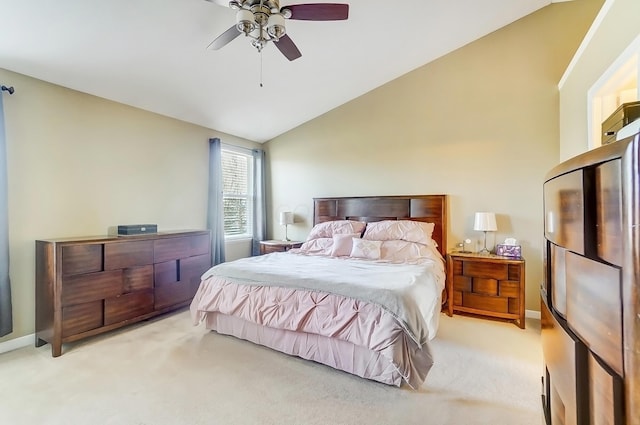 bedroom with vaulted ceiling, light colored carpet, baseboards, and ceiling fan