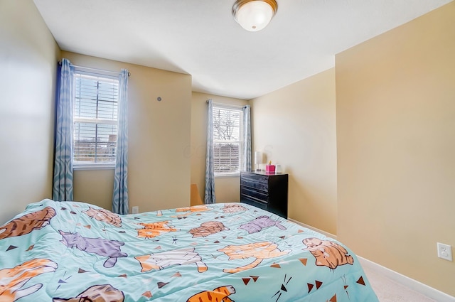 bedroom featuring baseboards and carpet flooring