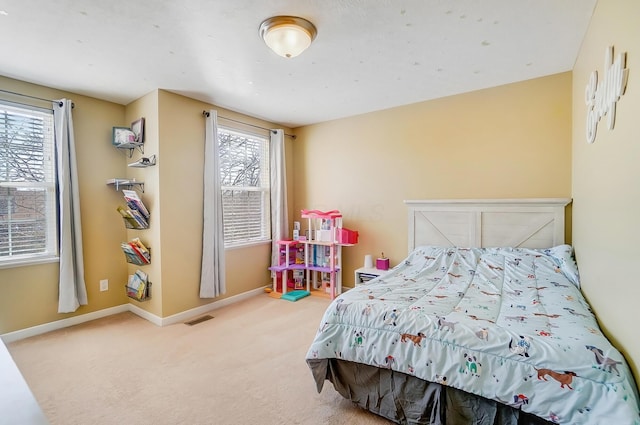 bedroom featuring visible vents, baseboards, and carpet floors