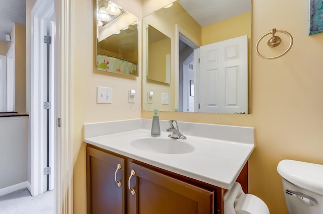 bathroom with toilet and vanity