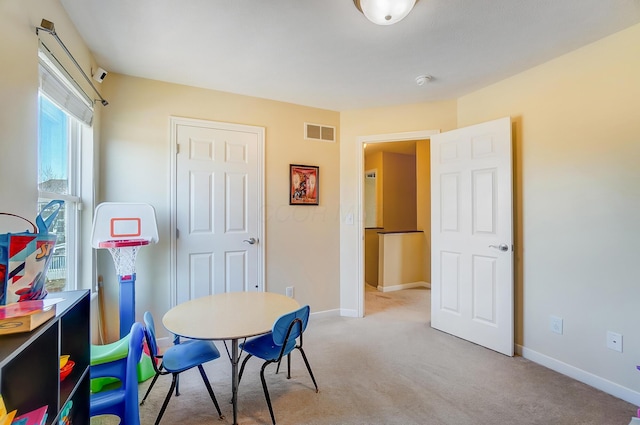 dining area featuring visible vents, baseboards, and light colored carpet