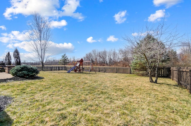 view of yard with a fenced backyard and a playground