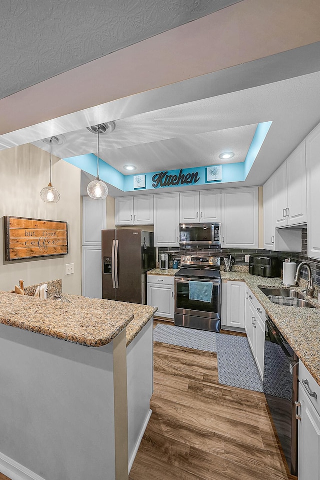 kitchen featuring white cabinetry, dark wood-type flooring, appliances with stainless steel finishes, and a sink