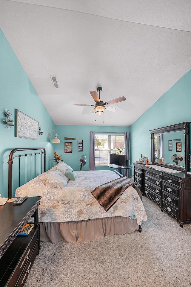 carpeted bedroom featuring visible vents, ceiling fan, and lofted ceiling