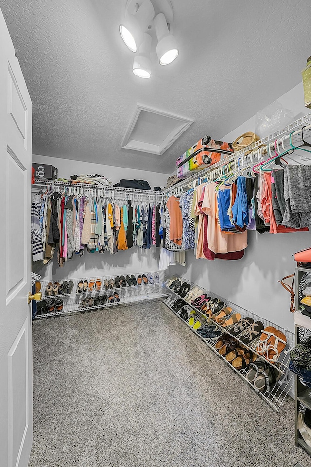 walk in closet featuring attic access