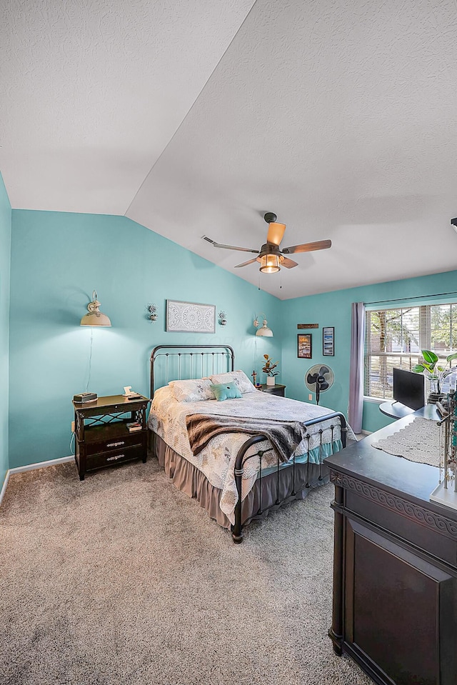 carpeted bedroom with baseboards, a textured ceiling, lofted ceiling, and a ceiling fan