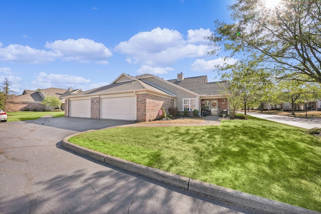 view of front of house featuring a front yard, an attached garage, a chimney, aphalt driveway, and brick siding