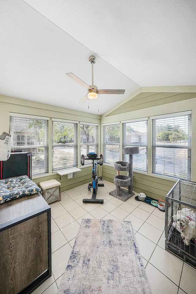 sunroom featuring a ceiling fan and vaulted ceiling