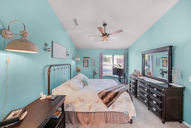 bedroom with vaulted ceiling, light colored carpet, visible vents, and ceiling fan