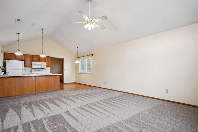 kitchen with white appliances, brown cabinetry, visible vents, light countertops, and open floor plan