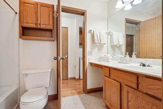 bathroom with tile patterned flooring, toilet, vanity, and baseboards