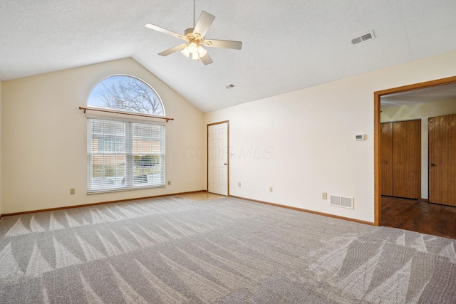 spare room featuring carpet, visible vents, and baseboards